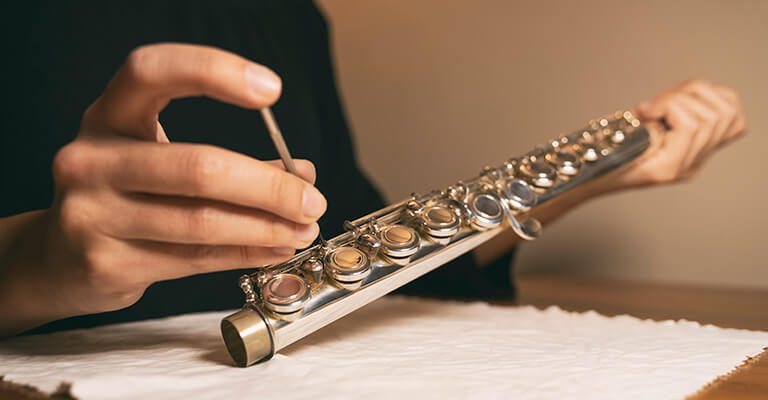 White House of Music technician repairing an instrument